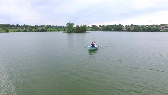 Wedding Couple Rowing Boat on the Pond