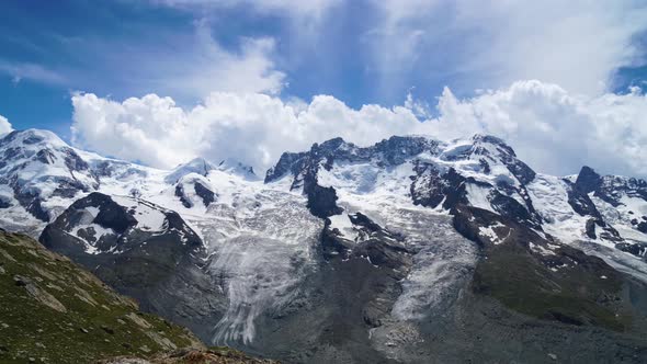 Timelapse of clouds forming and being pushed by the wind above alpine summits, Zermatt - Switzerland