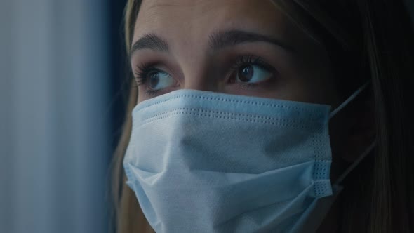 Young Sad Woman Wearing Protective Medical Mask on Face