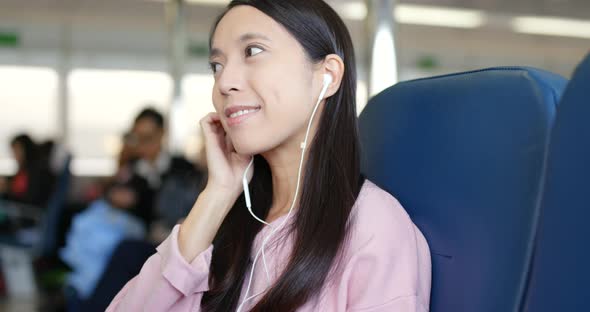 Woman listen to music on ferry