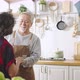 Asian mature senior couple is dancing and smiling in kitchen at home. - VideoHive Item for Sale