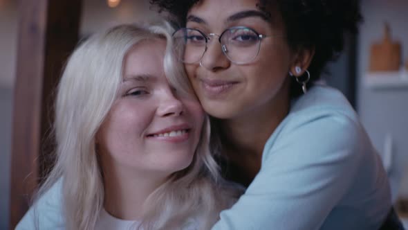 Close Shot of Young Girl Hugging Her Girlfriend From the Back and Smiling