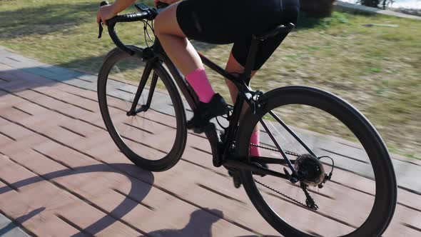 Triathlete cyclist riding bicycle, training on summer sunny day.