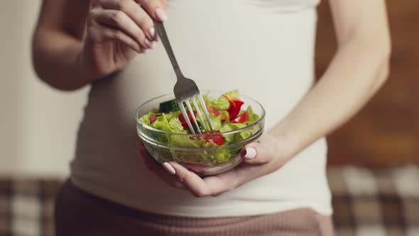 Close Up Shot of Pregnant Woman Enjoying Fresh Vegetable Salad Holding Glass Bowl Slow Motion