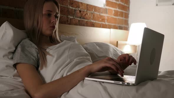 Woman Working on Laptop, Lying in Bed for Rest