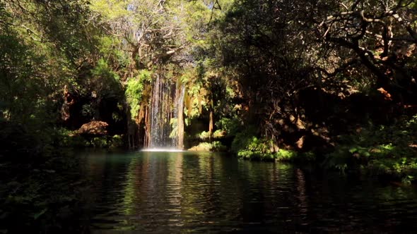 Footage of a small waterfall with a clear blue plunge pool in the Blyde River canyon Gorge on the Pa