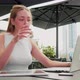 young woman sitting outdoors using computer videocalling - VideoHive Item for Sale