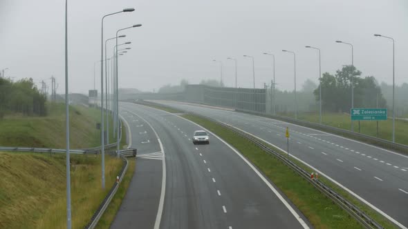 Highway With Passing Cars On A Rainy Day 2 alt