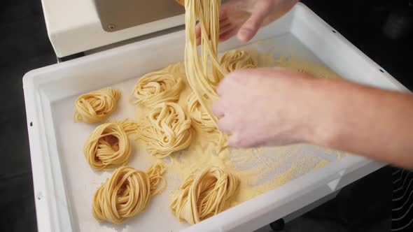 Man Making Fresh Pasta on Traditional Italian Kitchen Machine for Spaghetti Chef Preparing Fresca