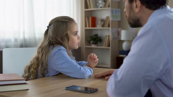 Father Discussing Gadget Addiction With His Little Daughter, Generation Conflict