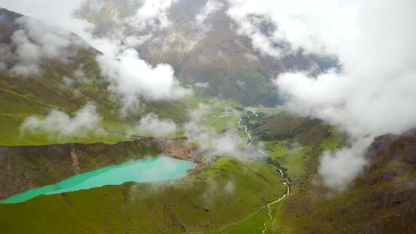 Aerial view of cloudy, snowy Humantay Lake, Peru.