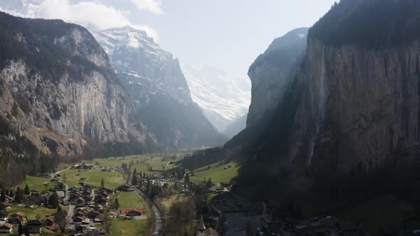 Aerial is descending and flying towards Lauterbrunnen town, Switzerland