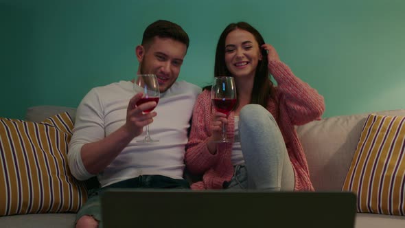 Young Couple Is Drinking Wine During Video Call