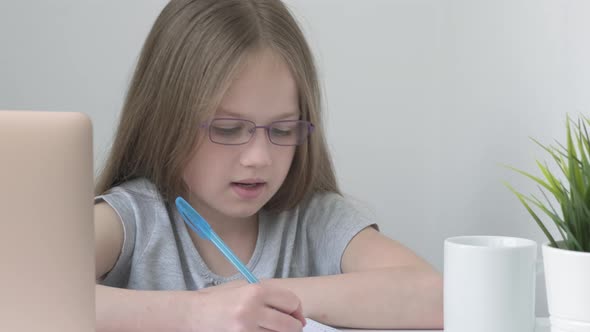 Caucasian Kid Studying Online Watching Web Class Lesson or Listening Tutor By Video Call Elearning