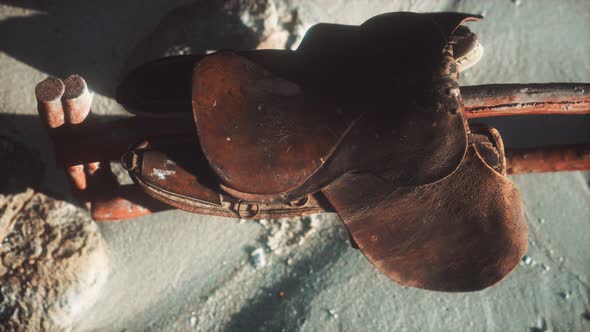 Rider Leather Saddle on Fence in Desert