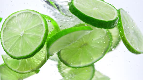 Super Slow Motion Shot of Fresh Lime Slices Rotating in Water at 1000 Fps