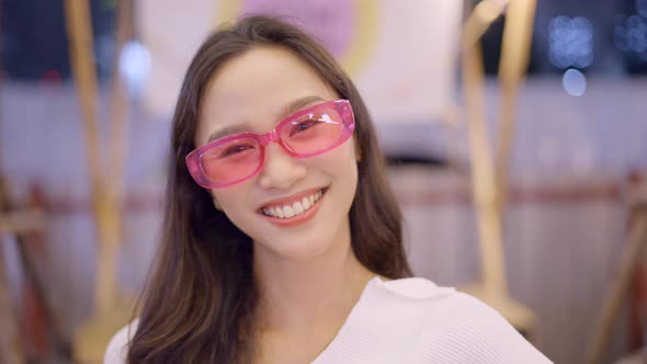 A Happy Beautiful Girl with Sunglasses Blur Background