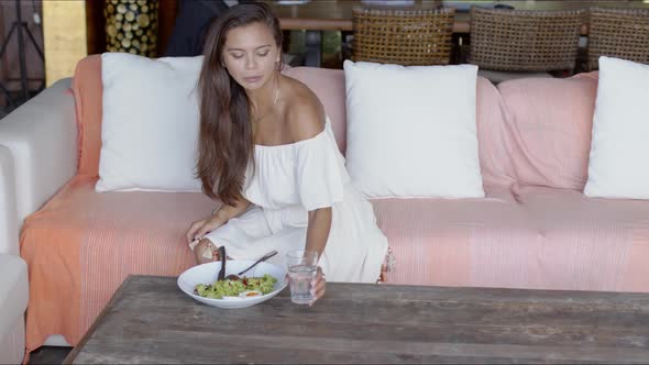 Pretty Woman Having Lunch and Drinking Water