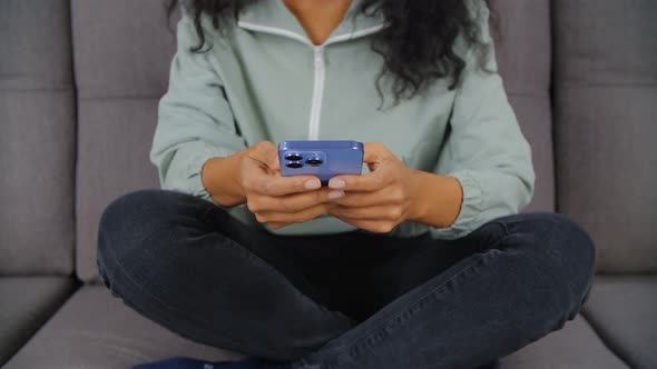 Black woman browsing internet in modern smartphone