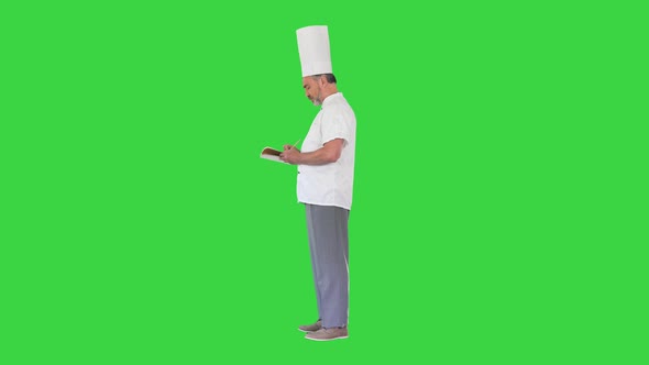 Male Chef Cook Making Notes on a Green Screen Chroma Key