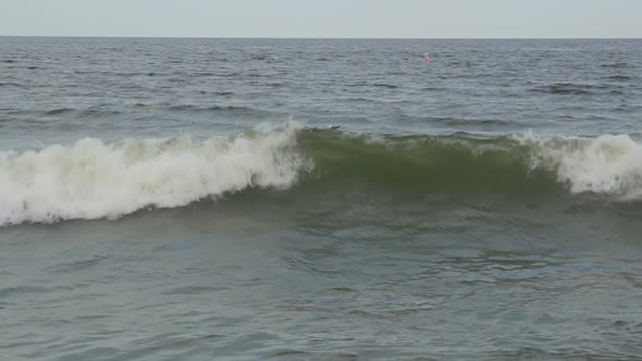 Blue water ocean wave blue swells crashing curling breaking a wavy surface close up