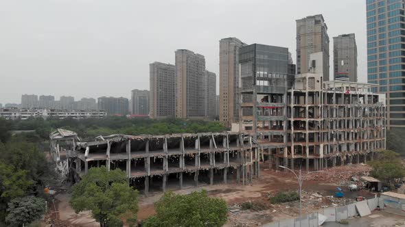 Aerial Moving Forward View of a Demolition Site with a Building