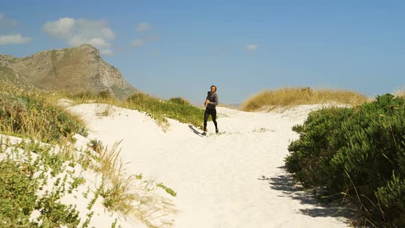 Triathlete man jogging on a trail