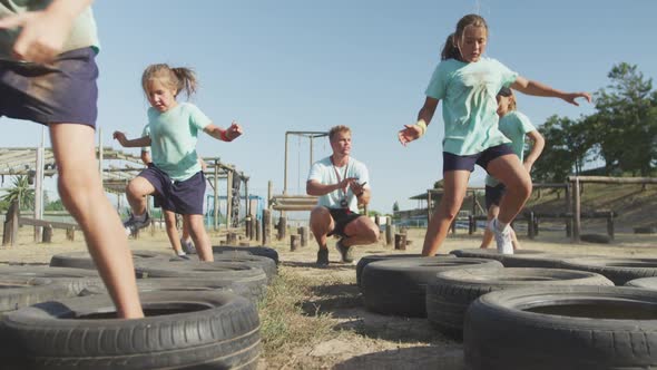 Group of Caucasian children training at boot camp