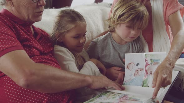 Senior couple at home with grandchildren