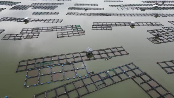 Aerial view of traditional floating fish pond on lake in Indonesia