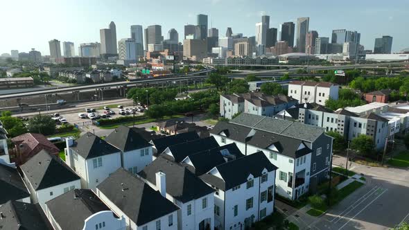 Houston Texas skyline. Rising aerial of residential homes to downtown urban skyscrapers and intersta