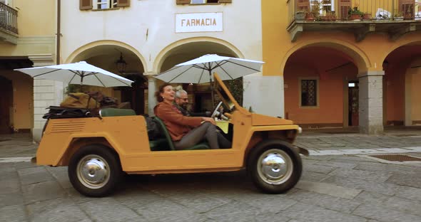 Aerial View of Man Driving His Yellow Car with His Girlfriend in a Desolated City