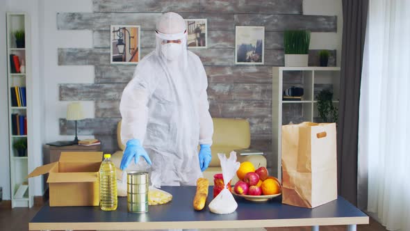 Man Wearing Hazmat Suit Putting Oil Bottle