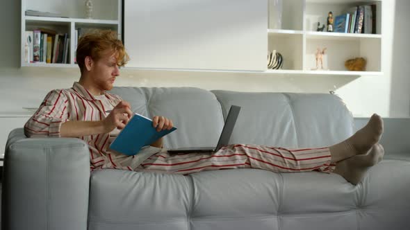 Manager Working Making Notes in Pajamas at Remote Office