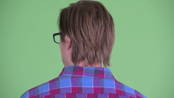 Closeup Rear View of Young Hipster Man Looking Around