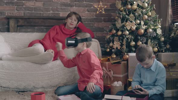 Brothers Have Fun with New Year Tech Presents Near Mother