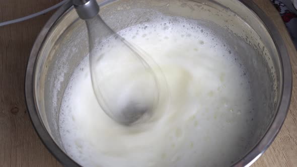 Eggs are Whipped with Mixer Into Foam for Making Protein Cream