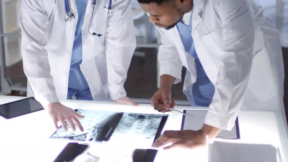 Caucasian and Afro-American Neurologists Studying CT Scans Together