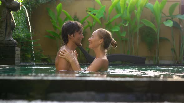 Young Couple Woman and Man Have Fun in Their Private Swimming Pool Honeymoon Concept