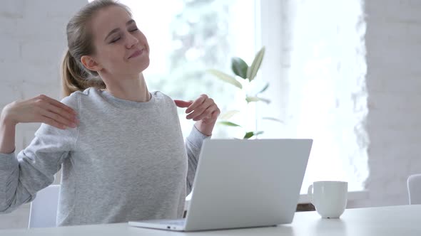 Tired Young Woman Trying to Relax Body By Stretching