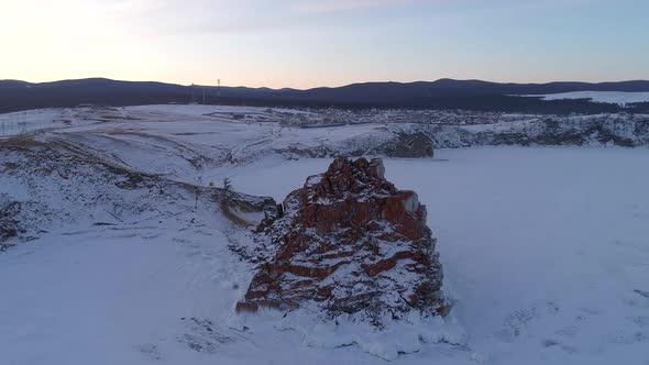 Aerial Orbital Shot of a Shamanka Rock on Olkhon Island at Sunset