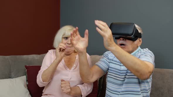 Grandfather and Grandmother with VR Headset Helmet Play Games, Watch Virtual Reality 3D 360 Video
