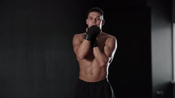 Athletic Shirtless Young Man Boxer Warming Up His Wrist