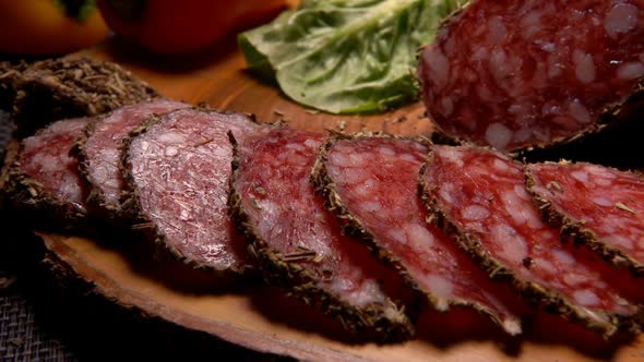 Slices of Dried Sausage in Herbs Taken with Fork