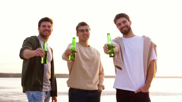 Young Men Toasting Non Alcoholic Beer on Beach