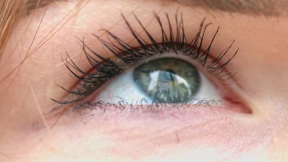 Close-up of woman's eye looking at business skyscrapers