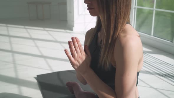 Wellness Young Female Meditates and Does Yoga a Calm Mood Relaxing in a White Room Filled with Light