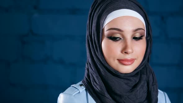 Young Muslim Woman in Black Hijab. Indoor Portrait