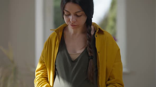 Pedestal Shot of Confident Pregnant Young Woman Tasting Delicious Vitamin Salad Indoors