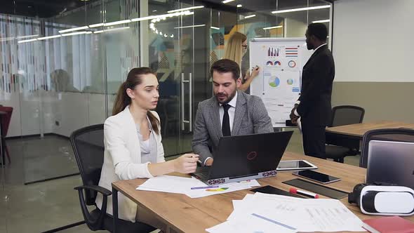 Business Colleagues which Working at the Meeting Table Using Computer